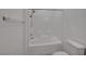 Bathroom featuring a shower-tub combo, toilet, and tiled wall at 1200 Paradise Basin Ct, Henderson, NV 89002