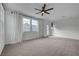 Upstairs bonus room is bright and inviting with neutral carpet, ceiling fan, and private balcony at 1200 Paradise Basin Ct, Henderson, NV 89002