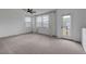 Bright bonus room featuring neutral carpet, ceiling fan, and many windows to let natural light in at 1200 Paradise Basin Ct, Henderson, NV 89002