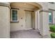 Welcoming townhome entrance featuring a covered porch, neutral colors, and brick flooring at 1200 Paradise Basin Ct, Henderson, NV 89002