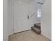 Welcoming entryway featuring tile flooring and a carpeted staircase with a white front door at 1200 Paradise Basin Ct, Henderson, NV 89002
