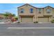 Attached two-car garage with neutral siding and trim, enhanced by manicured bushes and a nearby fire hydrant at 1200 Paradise Basin Ct, Henderson, NV 89002