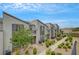 Exterior view of the modern townhome complex featuring desert landscaping at 1200 Paradise Basin Ct, Henderson, NV 89002