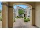 Charming townhome exterior framed by an arched entry, showcasing well-kept landscaping and a cozy community feel at 1200 Paradise Basin Ct, Henderson, NV 89002