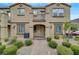 Inviting townhome exterior with well-maintained landscaping and a brick walkway leading to the front door at 1200 Paradise Basin Ct, Henderson, NV 89002