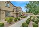 Townhome exterior featuring manicured landscaping, with a charming walkway leading to the inviting front entrance at 1200 Paradise Basin Ct, Henderson, NV 89002