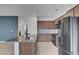Modern kitchen featuring stainless steel appliances, a granite countertop island, and tile backsplash at 1200 Paradise Basin Ct, Henderson, NV 89002