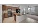 Stylish kitchen features a large island and black appliances that enhance the home's modern look at 1200 Paradise Basin Ct, Henderson, NV 89002