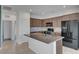 Bright kitchen with granite island, tile backsplash, stainless appliances, and open access at 1200 Paradise Basin Ct, Henderson, NV 89002