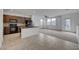 Open concept living space, featuring modern kitchen, tile floors, and ample natural light at 1200 Paradise Basin Ct, Henderson, NV 89002