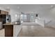 Bright living room and kitchen area featuring granite countertops, tile floors, and stainless steel appliances at 1200 Paradise Basin Ct, Henderson, NV 89002