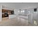 Open concept living space, featuring modern kitchen, tile floors, and ample natural light at 1200 Paradise Basin Ct, Henderson, NV 89002