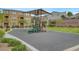 Bright community playground with shade, play equipment and seating amid lush landscaping and residential buildings at 1200 Paradise Basin Ct, Henderson, NV 89002