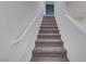 Carpeted staircase with white railing, leading upstairs with bright and clean design at 1200 Paradise Basin Ct, Henderson, NV 89002