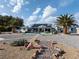 Expansive backyard features a patio, built-in pool, palm trees, solar panels and a well-maintained desert landscape at 1251 Cavalry St, Pahrump, NV 89048