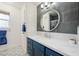 Modern bathroom with marble counters, gray tile accent wall, and decorative patterned flooring at 1251 Cavalry St, Pahrump, NV 89048