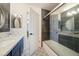 Stylish bathroom featuring a glass-enclosed shower, gray tile accent, and modern vanity at 1251 Cavalry St, Pahrump, NV 89048