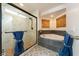 Bright bathroom with marble shower, soaking tub, and stylish fixtures at 1251 Cavalry St, Pahrump, NV 89048