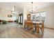 Open-concept dining area, hardwood style floors, grand dining table and decorative light fixtures at 1251 Cavalry St, Pahrump, NV 89048