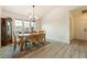 Bright dining room featuring a wooden table, chairs and light fixture and hardwood style floors at 1251 Cavalry St, Pahrump, NV 89048