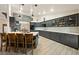 Bright kitchen with dark gray cabinets, stainless appliances, island seating, and lots of natural light at 1251 Cavalry St, Pahrump, NV 89048