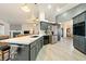 Modern open concept kitchen with stainless appliances, stone backsplash, and kitchen island at 1251 Cavalry St, Pahrump, NV 89048