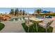 Sparkling pool with ample seating and outdoor dining area surrounded by lush greenery at 1251 Cavalry St, Pahrump, NV 89048