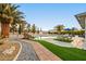 Inviting backyard with a beautiful pool, patio area, and lush landscaping at 1251 Cavalry St, Pahrump, NV 89048