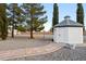Backyard shed with paved pathway and manicured landscaping at 1251 Cavalry St, Pahrump, NV 89048