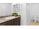A clean bathroom is equipped with granite counters and a framed mirror at 1323 Cerulean Ave, Henderson, NV 89002