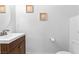 Half bathroom featuring white walls, tile flooring, small sink, toilet, and decorative wall art at 1323 Cerulean Ave, Henderson, NV 89002