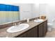Bathroom with dual sinks, granite counters, and neutral finishes at 1323 Cerulean Ave, Henderson, NV 89002