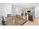 Open dining area with tile flooring, wooden table with chairs, and open concept view of living area at 1323 Cerulean Ave, Henderson, NV 89002
