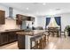 Modern kitchen with stainless steel appliances, granite counters and dining area with bar seating at 1323 Cerulean Ave, Henderson, NV 89002