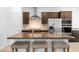 Modern kitchen featuring a center island with bar seating, stainless steel appliances, and granite counter tops at 1323 Cerulean Ave, Henderson, NV 89002
