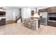 Open-concept kitchen featuring granite counters, stainless steel appliances, and breakfast bar with seating at 1323 Cerulean Ave, Henderson, NV 89002