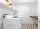 Clean laundry room with modern appliances and stylish patterned flooring at 1323 Cerulean Ave, Henderson, NV 89002