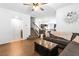 Spacious living room with wood floors, fireplace, stairs, sofa and view of the kitchen at 1323 Cerulean Ave, Henderson, NV 89002