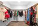 Bright walk-in closet with ample storage and clothing racks on both sides at 1323 Cerulean Ave, Henderson, NV 89002