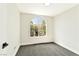 Bright bedroom features a unique arched window offering outdoor views and comfortable gray carpeting at 1724 Navajo Lake Way, Las Vegas, NV 89128