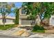 Charming two-story home with a well-maintained lawn and mature trees, enhancing its curb appeal at 1724 Navajo Lake Way, Las Vegas, NV 89128