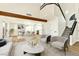 Open-concept living room showing a dining room and staircase with sleek furniture and modern decor at 1724 Navajo Lake Way, Las Vegas, NV 89128