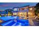 Backyard features a pool and jacuzzi with outdoor seating, with views of the house at sunset at 1972 Alcova Ridge Dr, Las Vegas, NV 89135