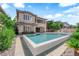 Gorgeous home exterior with pool, lush landscaping, and a covered patio for outdoor entertaining at 1972 Alcova Ridge Dr, Las Vegas, NV 89135