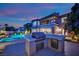 Backyard with stainless steel grill and prep area next to the beautiful pool and spa at dusk at 1972 Alcova Ridge Dr, Las Vegas, NV 89135