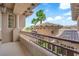 Elegant balcony with ornate railings and columns, showcasing neighborhood views and clear blue sky at 1972 Alcova Ridge Dr, Las Vegas, NV 89135