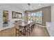 Dining area with a large window view, modern light fixture, and seating for eight at 1972 Alcova Ridge Dr, Las Vegas, NV 89135