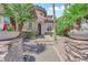 An arched entryway has a pathway up to the front door, desert landscaping, and rock features at 1972 Alcova Ridge Dr, Las Vegas, NV 89135