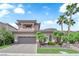 A beautiful home has a large garage, neutral exterior, desert landscaping, and palm trees at 1972 Alcova Ridge Dr, Las Vegas, NV 89135