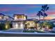 Beautiful two-story home with a three car garage and palm trees at 1972 Alcova Ridge Dr, Las Vegas, NV 89135
